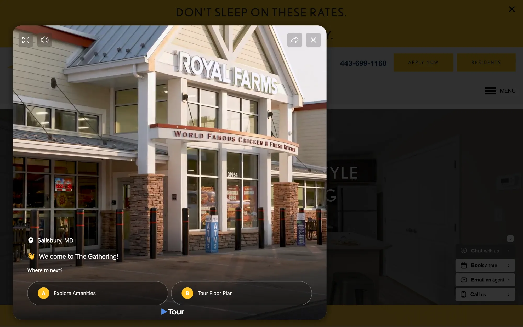 The same page with the widget opened in place: a rounded video panel over the dimmed site, an aerial shot playing, and two lettered options reading “A Explore Amenities” and “B Tour Floor Plan”.